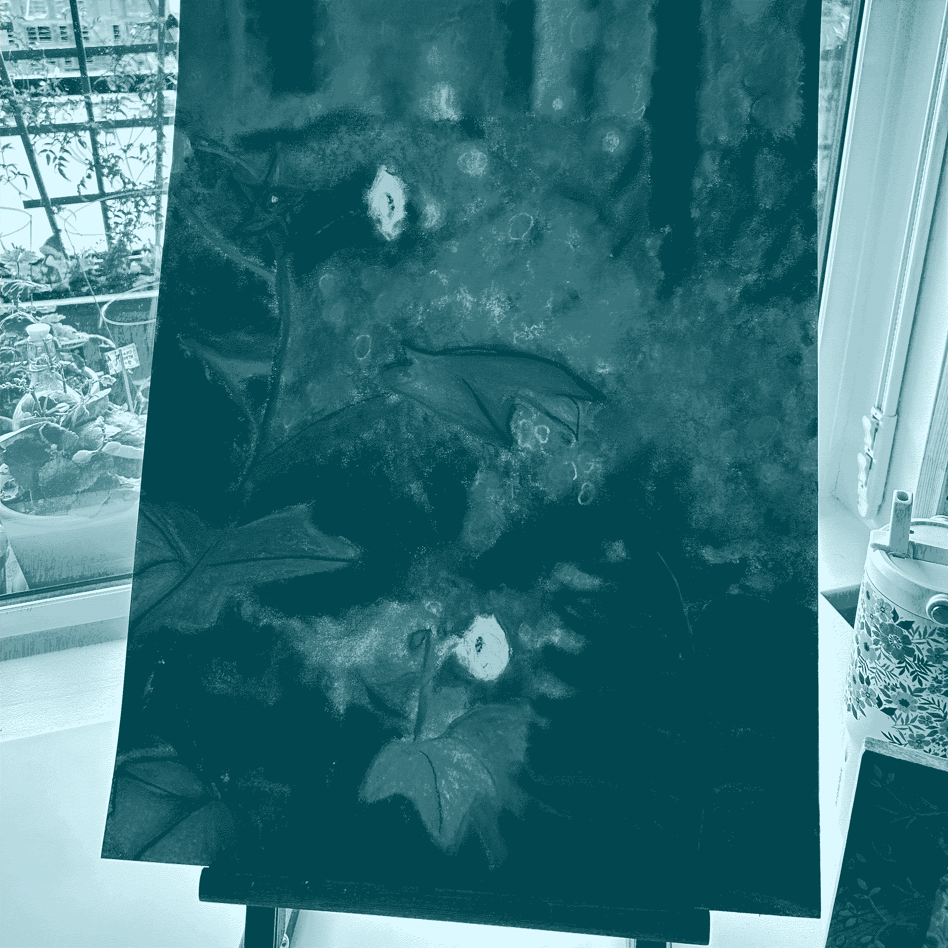 a chalk pastel drawing of a thimble berry blossom and a fern sit on an easel, in the background a young jasmine blooms. 