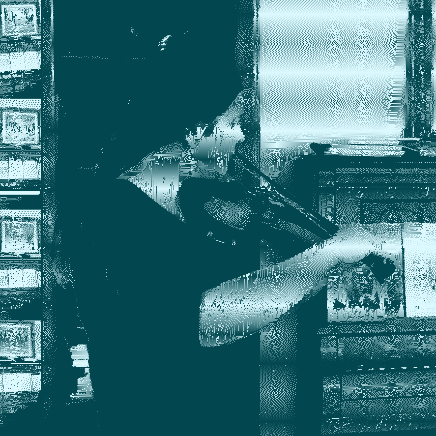 claire plays her fiddle, in front of a piano and a bookshelf. 